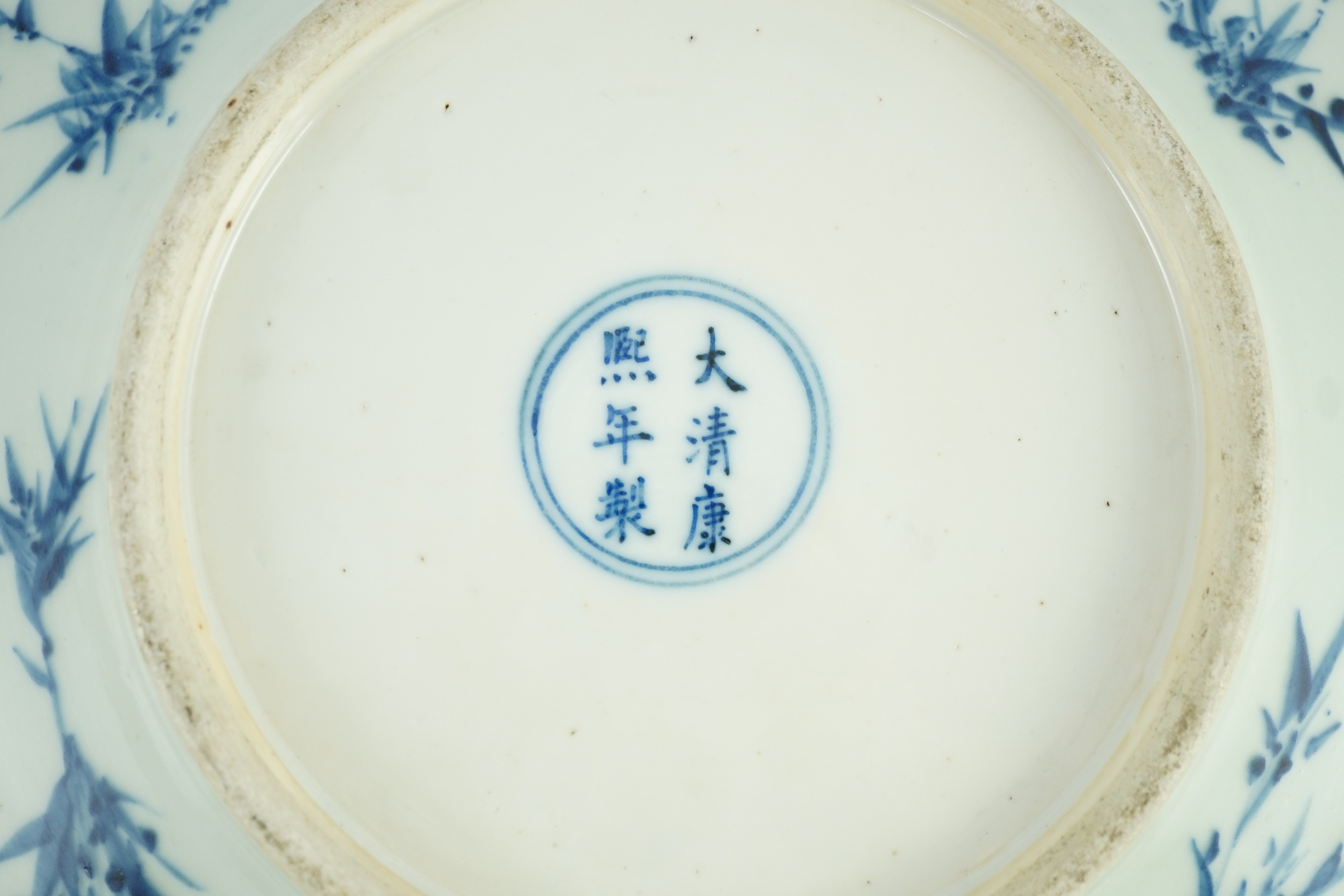 A Chinese blue and white dish, Kangxi mark, 19th century, 34.5cm diameter